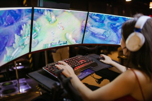Girl gamer playing online game on desktop - Why online gaming addiction is harmful excessive gaming - The Gamerian Blog