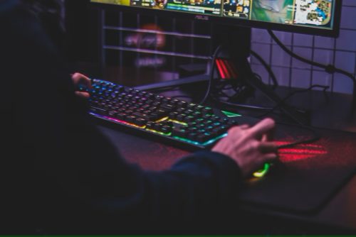 Unknown person playing games online with RGB keyboard and mouse - Online Gaming in Michigan - thegamerian.com gaming blog