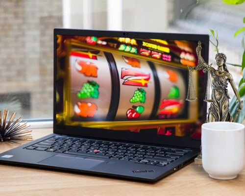 A computer on table showing slot machine reels up close - Newest RTG Casinos - The Gamerian thegamerian.com Gaming Blog